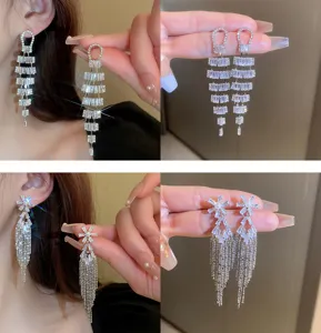 Elegant silver rhinestone tassel earrings detail shot, sparkling crystal long drop jewelry for women.