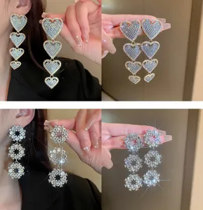 Detailed view of long rhinestone heart and circle drop earrings, elegant fashion jewelry for women.