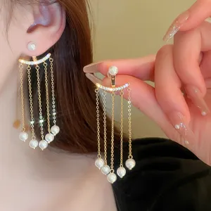 Close-up detail shot of elegant gold-toned multi-strand pearl tassel earrings with crystal accents.