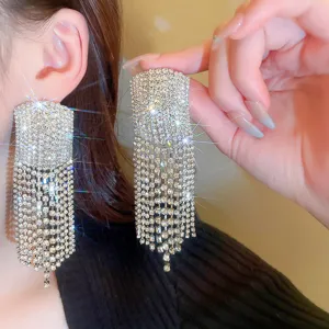 Stunning crystal rhinestone fringe earrings detail view, sparkling luxury tassel ear studs for women.