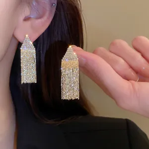 Gold rhinestone fringe drop earrings for women, sparkling long tassel statement jewelry design.