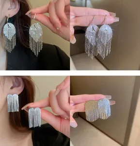 Close-up detail shot of sparkling rhinestone tassel earrings, showcasing exquisite craftsmanship and chain.