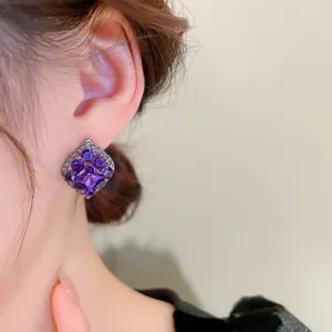 Close-up of French vintage style purple crystal rhinestone ear studs showing delicate details.