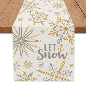 Christmas table runner with golden grey snowflakes and Let It Snow text for holiday home decor.