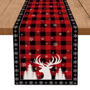 Christmas red black buffalo plaid table runner with cute deer and snowflake prints for holiday.