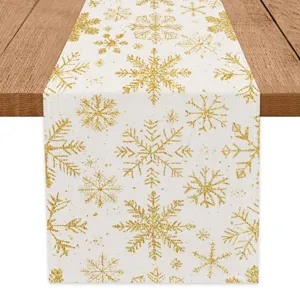 Gold glitter snowflake table runner for Christmas holiday dining table home decoration.