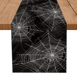Halloween spider web table runner detail view, spooky black and white holiday home decor.