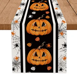 Halloween pumpkin spider web table runner, spooky holiday dining table decoration detail view.