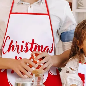 Christmas apron detail view, waterproof kitchen bib with festive print, holiday party style.