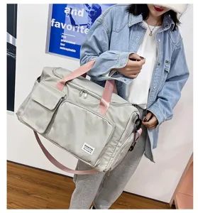 Light grey travel duffel bag detail, oxford cloth material, pink straps, multi-pocket design.