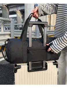 Duffel bag luggage sleeve detail showing convenient trolley attachment for travel and gym trips.