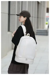 Stylish white waterproof canvas backpack with shoe compartment and large capacity, ideal for travel.