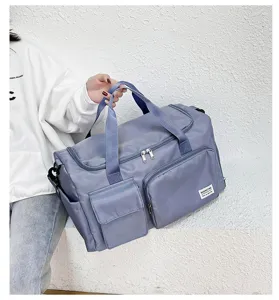 Grey blue oxford cloth travel gym duffel bag with multiple pockets and shoulder strap.