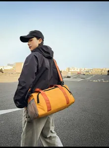 Outdoor lifestyle detail shot of a large capacity travel duffel bag with yellow color.