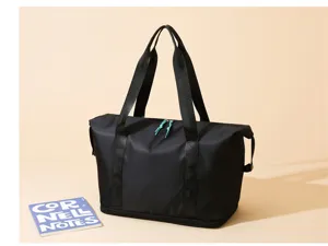 Close-up detail of the black fitness travel bag showcasing durable handles and smooth zipper.
