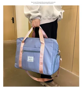 Large capacity travel duffel bag with pink straps, ideal for gym, sports and weekend trips.
