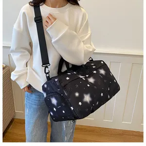 Detail view of casual travel duffel bag featuring starry print and side shoe compartment.