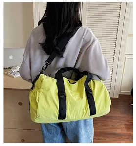 Casual travel duffel bag for sports and fitness, waterproof nylon material with shoulder strap.