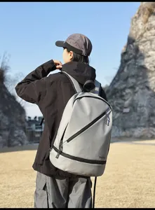 Grey waterproof sports backpack detail showing durable fabric and modern diagonal zipper design.