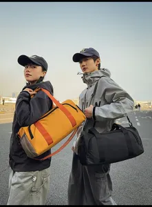 Outdoor scene detail showing large capacity sports duffel bag with dual handles and straps.
