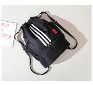 Black oxford cloth sports drawstring backpack detail showing the three white stripes design.
