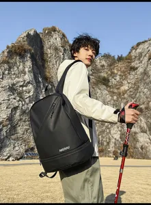 Outdoor scene detail shot showcasing a waterproof black backpack with shoe compartment.