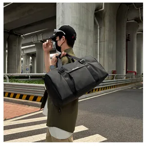 Detail view of large capacity black sports duffel bag with dry wet separation for fitness travel.