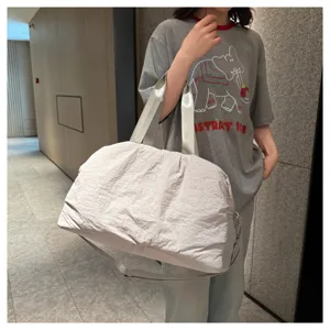 Close-up detail of a large capacity travel gym duffel bag in light grey, stylish and practical.