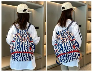 Large capacity sports backpack with letter print and drawstring design for men training.