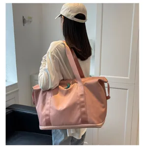 Detailed view of large capacity pink oxford cloth fitness travel bag with shoulder strap.