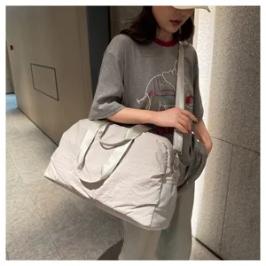 Spacious light grey travel duffel bag with a solid shoulder strap and practical handles.