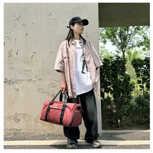 Large capacity red sports duffel bag for travel, gym, and yoga training with wet dry separation.