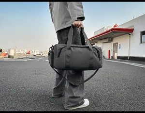 Large capacity sports duffel bag with shoe compartment, grey travel bag for gym use.