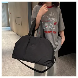 Large capacity travel duffel bag with shoulder strap, ideal for sports and gym use.