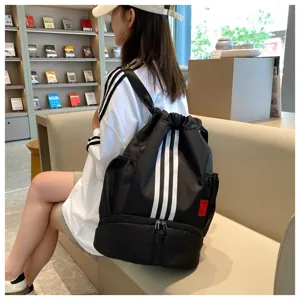 Detailed view of black drawstring backpack with white stripes in modern indoor setting.