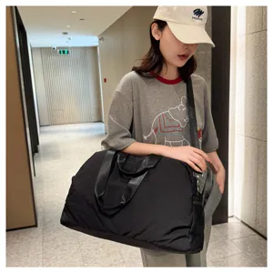 Large capacity black travel duffel bag for sports and fitness with wet dry separation design.