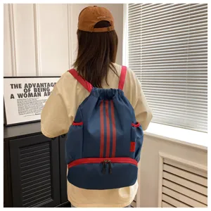 Blue drawstring backpack with red stripes and bottom compartment for sports and daily use.