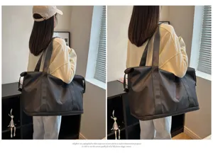 Detail view of a solid color travel duffel bag, spacious design for gym and weekend trips.