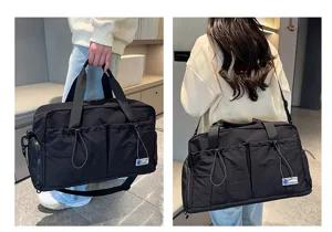 Detailed view of large capacity black travel fitness bag with shoulder strap and multi pockets.