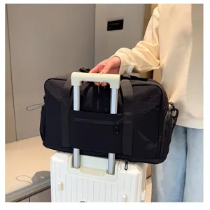 Large capacity black travel duffle bag with trolley sleeve detail shot for convenient travel use