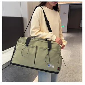Stylish large capacity travel shoulder bag for women, multi-pocket canvas fitness duffel.