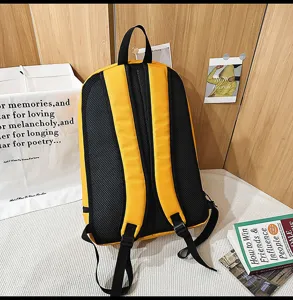 Details view of the yellow and black waterproof backpack showing breathable mesh back pads.
