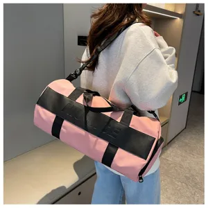 Large capacity pink sports duffel bag for fitness, travel and gym use with crossbody strap.