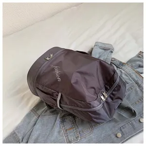 Detailed view of dark grey oxford fabric casual backpack featuring zipper pockets.