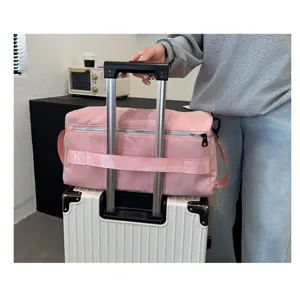 Large capacity pink travel duffel bag with luggage handle sleeve for short trips and gym use.