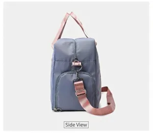 Side view detail of the travel duffel bag, showing durable gray fabric and pink strap.