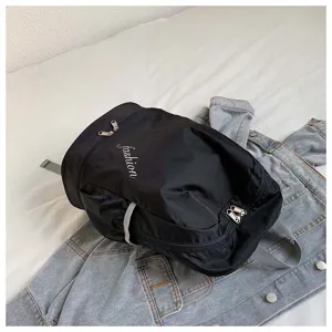 Close-up detail view of the black nylon casual backpack with zipper pocket and fashion text.