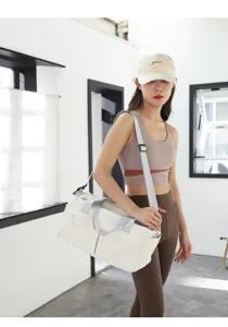 Minimalist beige nylon gym bag with grey straps, spacious travel duffel for women.