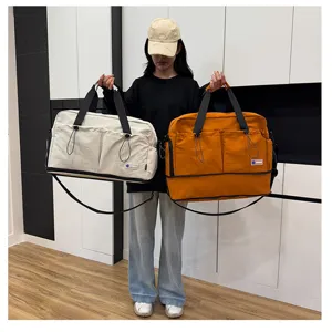 Large capacity travel duffel bag with shoulder strap, casual multi-pocket design for gym.