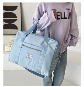 Detailed view of large capacity blue travel duffel bag with front pocket and durable handles.